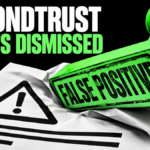 A giant green false-positive stamp presses down on an alert document.